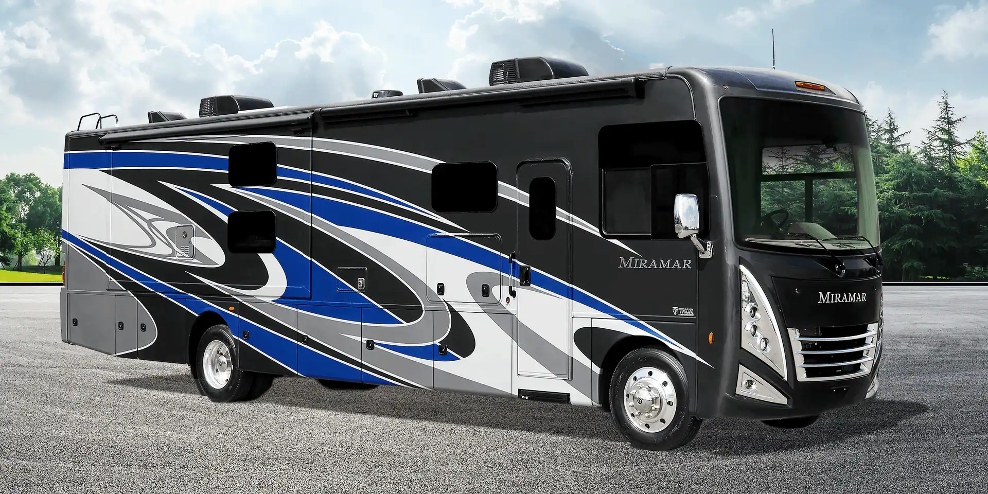 A black and blue rv parked on the side of road.