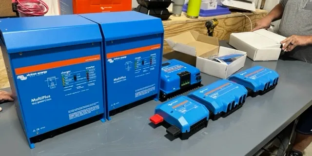 A table with some blue boxes and batteries