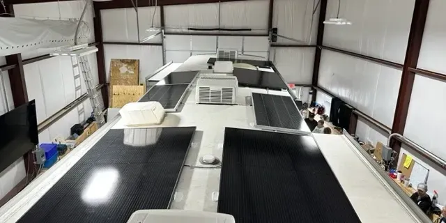 A large black and white airplane in an airport hangar.